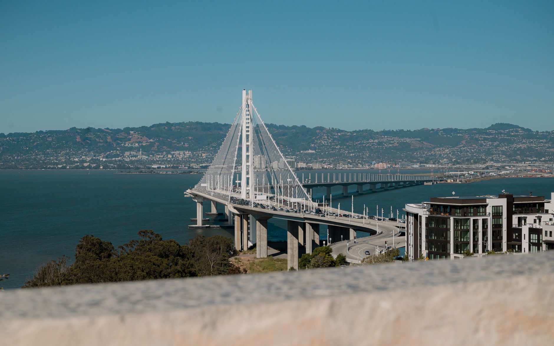 The eastern span of the San Francisco-Oakland Bay Bridge crossing the water toward the East Bay hills